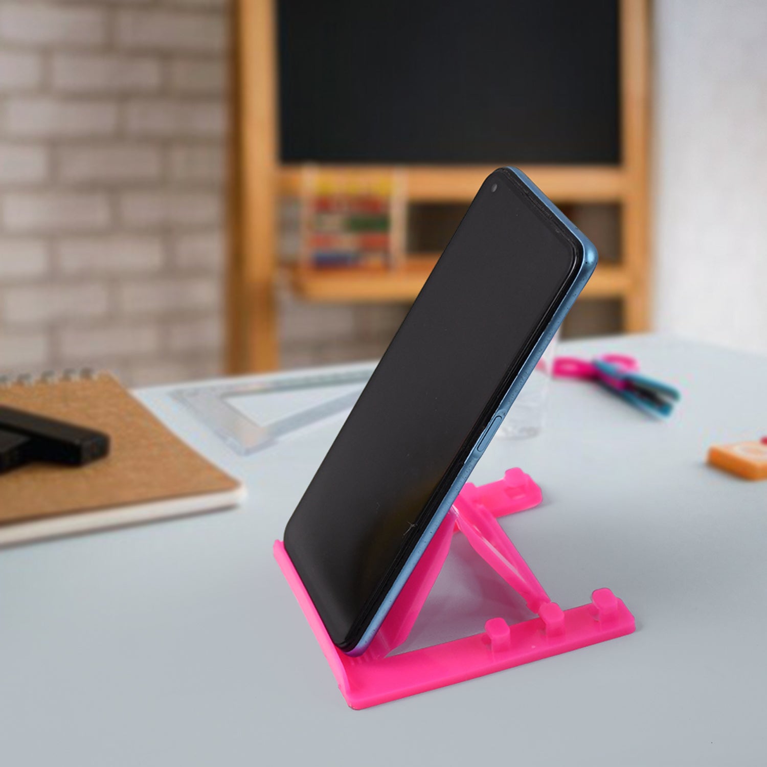 Sturdy plastic mobile phone stand supporting multiple smartphone sizes