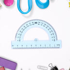 Essential transparent geometry instruments including protractor and set squares for technical drawing
