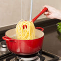 Silicone pasta fork with spaghetti, demonstrating easy serving.