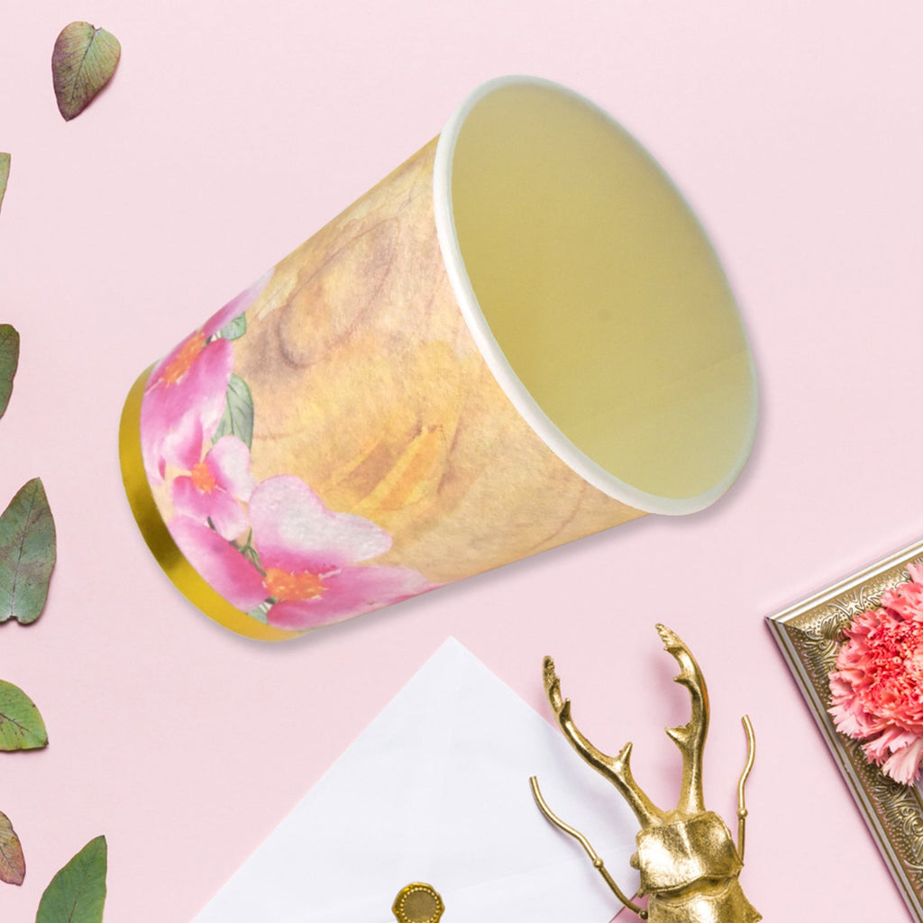 Variety of disposable paper cups in different patterns and colors, perfect for any event.