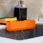 Plastic sink drainer shelf positioned over a kitchen sink, demonstrating its use as a storage holder.