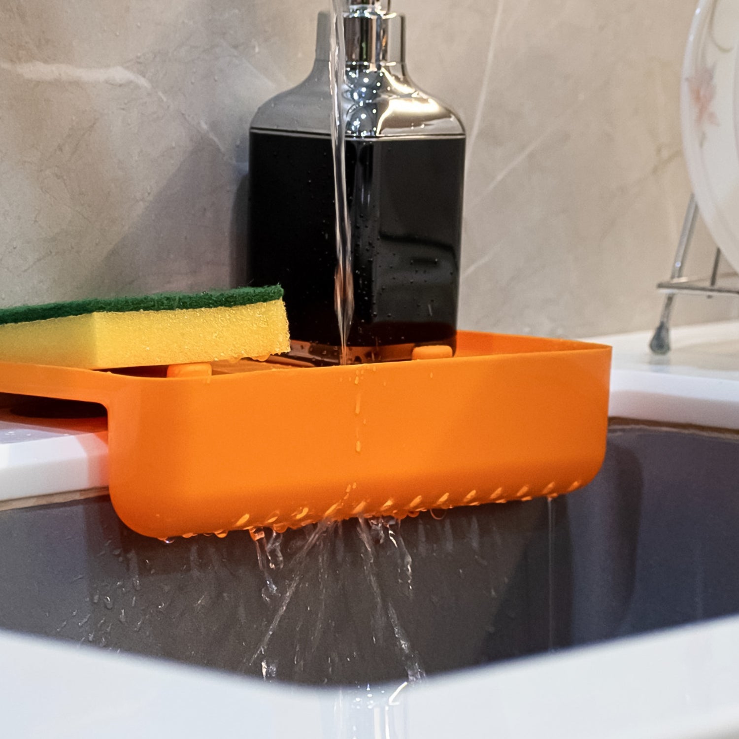 Plastic sink drainer shelf positioned over a kitchen sink, demonstrating its use as a storage holder.
