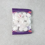 Close-up image of round naphthalene mothball tablets for wardrobe freshness