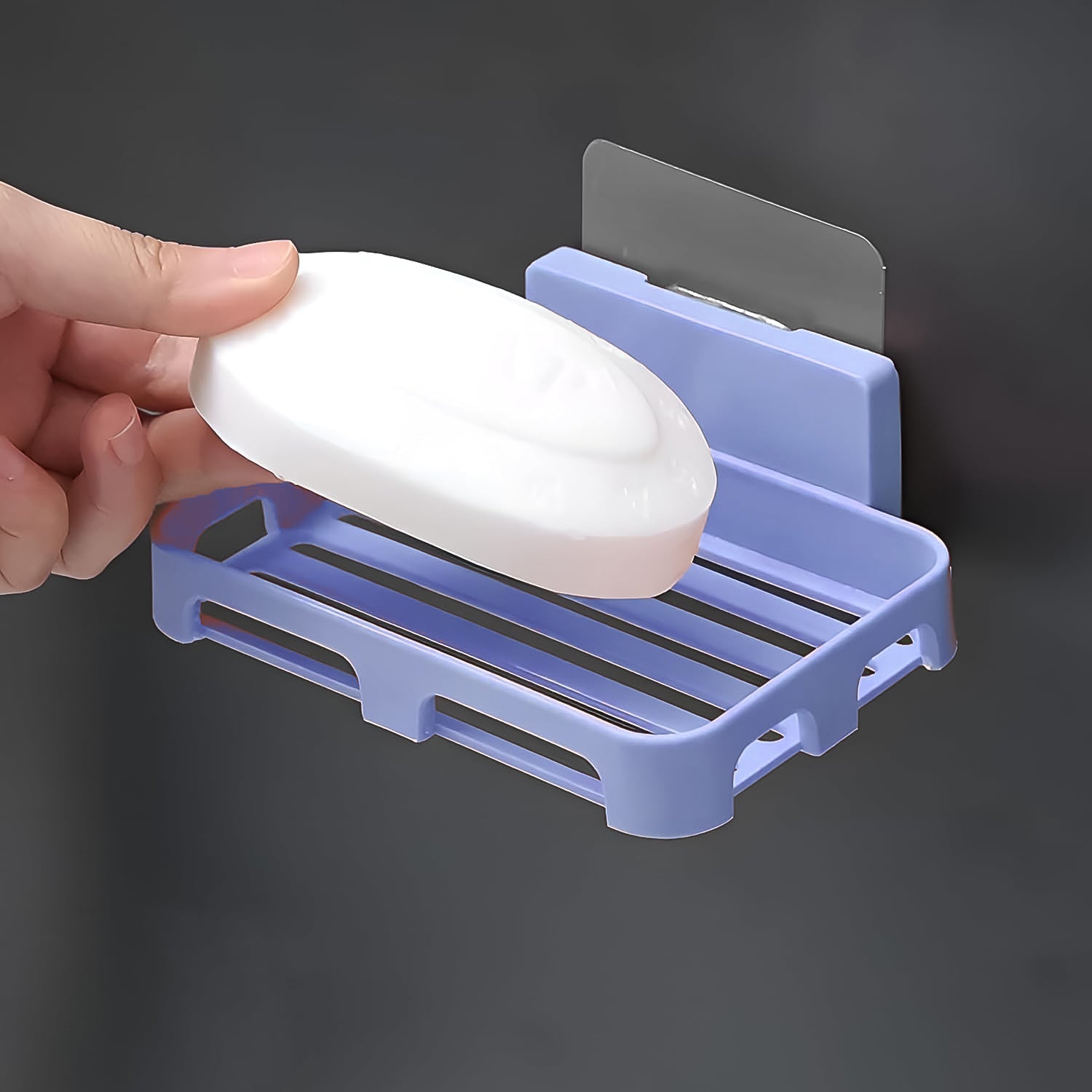 Side profile of the sleek, compact self-adhesive soap holder on a white wall.