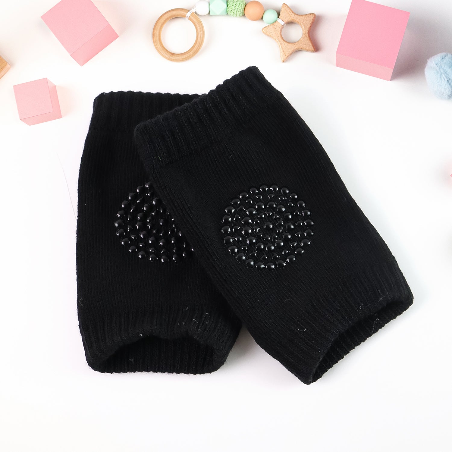 Soft black wool knee guards for young children to protect knees during crawling