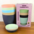 Top-down view of the complete 5-piece plastic flower pot set, showcasing their uniform design.