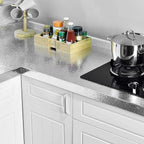 Cabinet surface enhanced with practical, washable aluminum foil wallpaper.