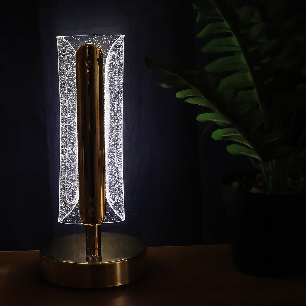 Golden crystal table lamp glowing warmly in living room decor