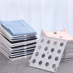 Versatile Clothes Folding Board used to organize various clothing items like pants and sweaters.