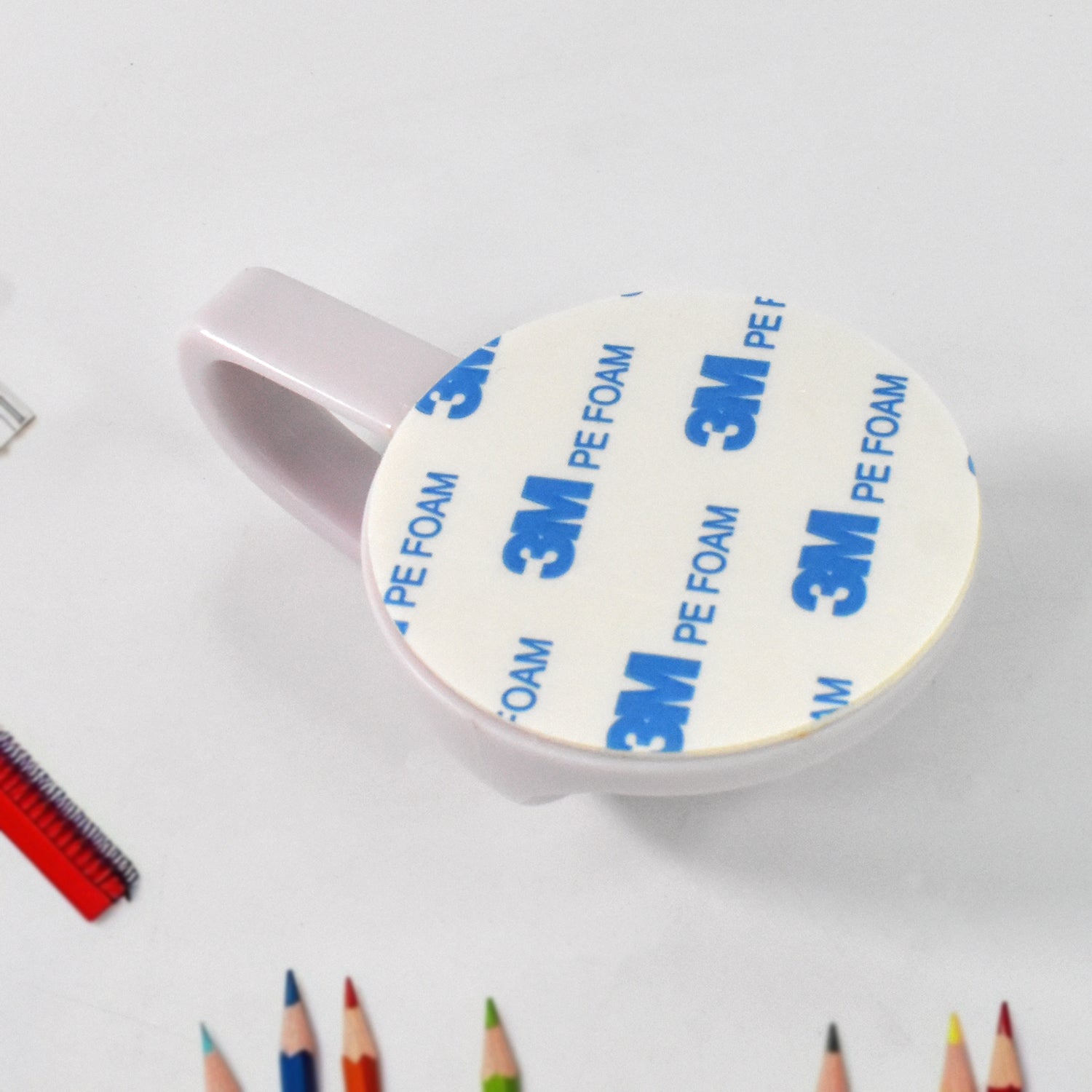 HoldStrong self-adhesive wall hook showing strong adhesive backing.