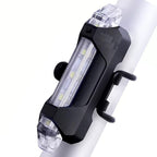 Rechargeable LED bicycle light with USB charging port for convenient power.