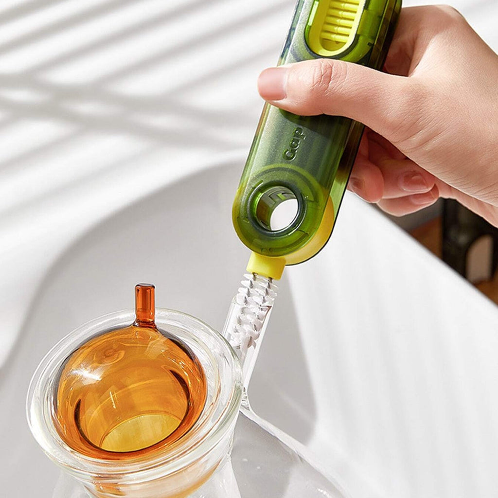 The bottle cleaning brush reaching the bottom of a narrow glass for thorough cleaning.