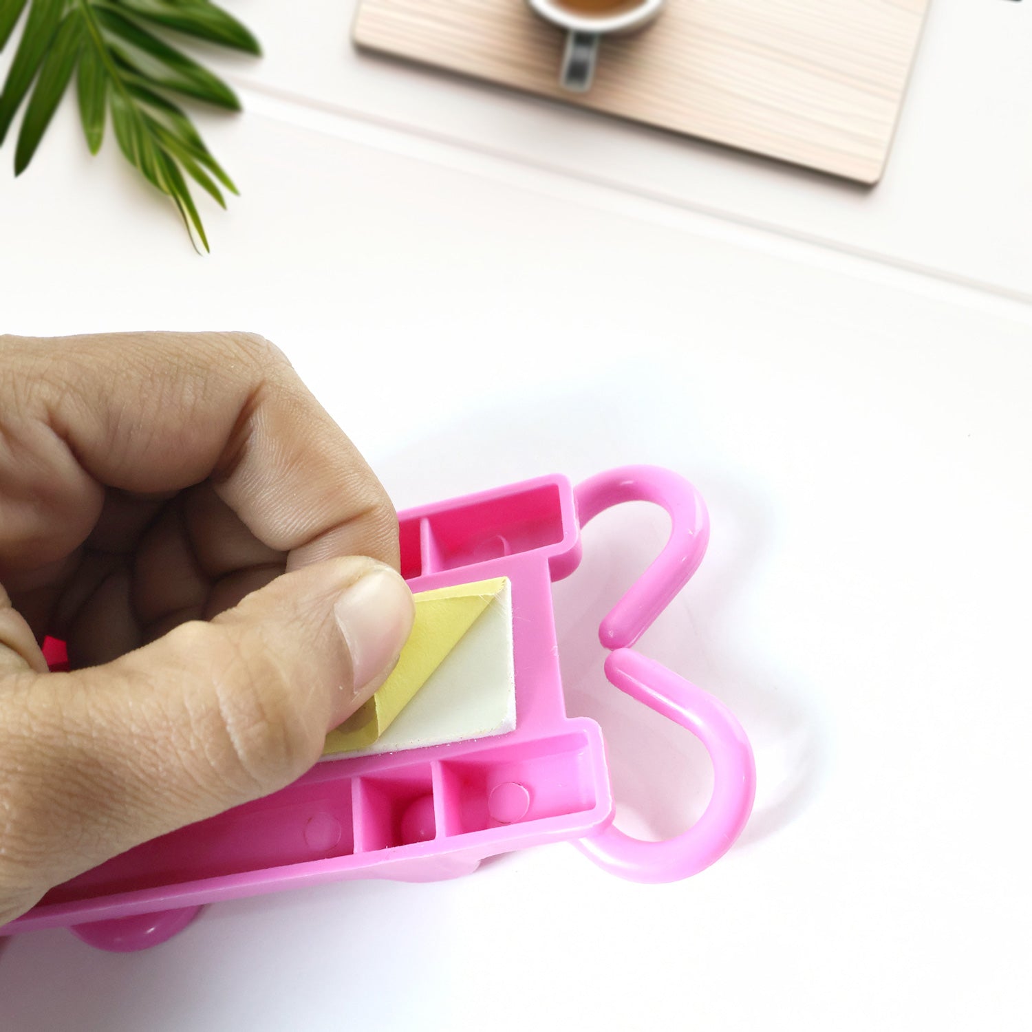 Pink multi-purpose hanging organizer folded to save space
