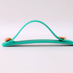 Phone grip strap in teal green used as a kickstand