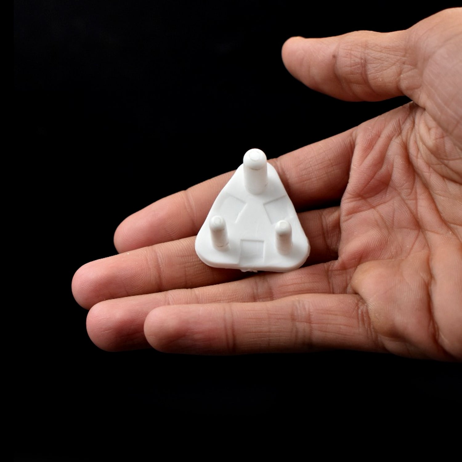 Multiple white baby safety socket covers shown in a protective pack.