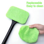Car windshield cleaner wiper being used inside a car to clean the front window.