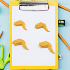 Side view of the chicken erasers, showing their three-dimensional form and playful appearance.