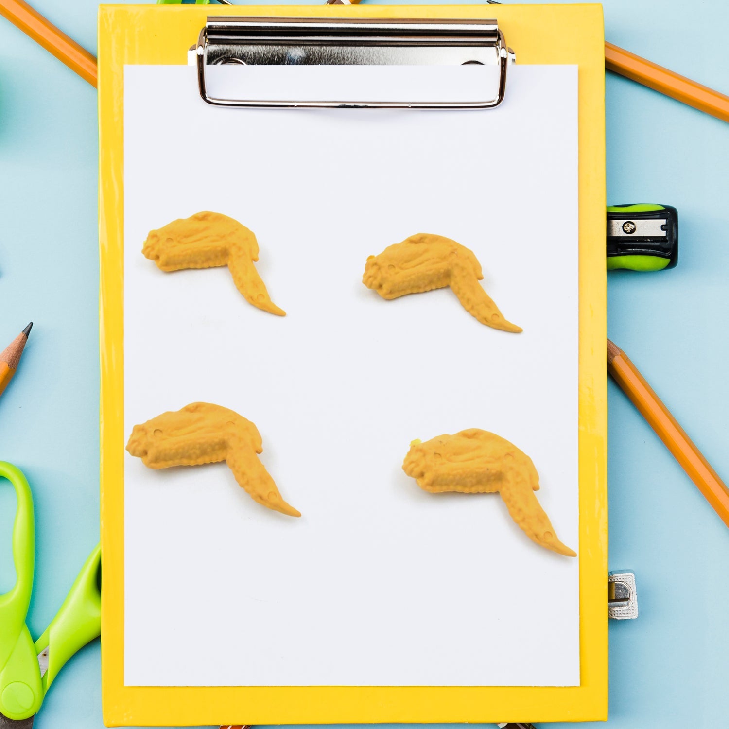 Side view of the chicken erasers, showing their three-dimensional form and playful appearance.