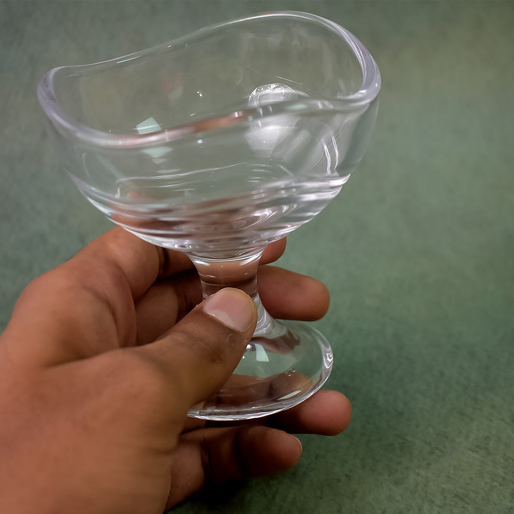 Front view of a single clear glass dessert bowl, empty and ready.