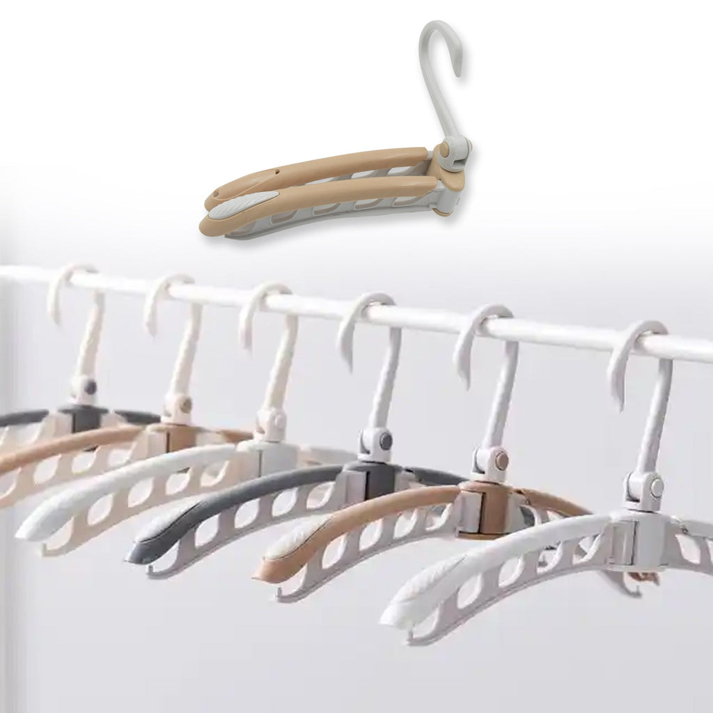 User demonstrating the easy folding mechanism of the clothes hanger.