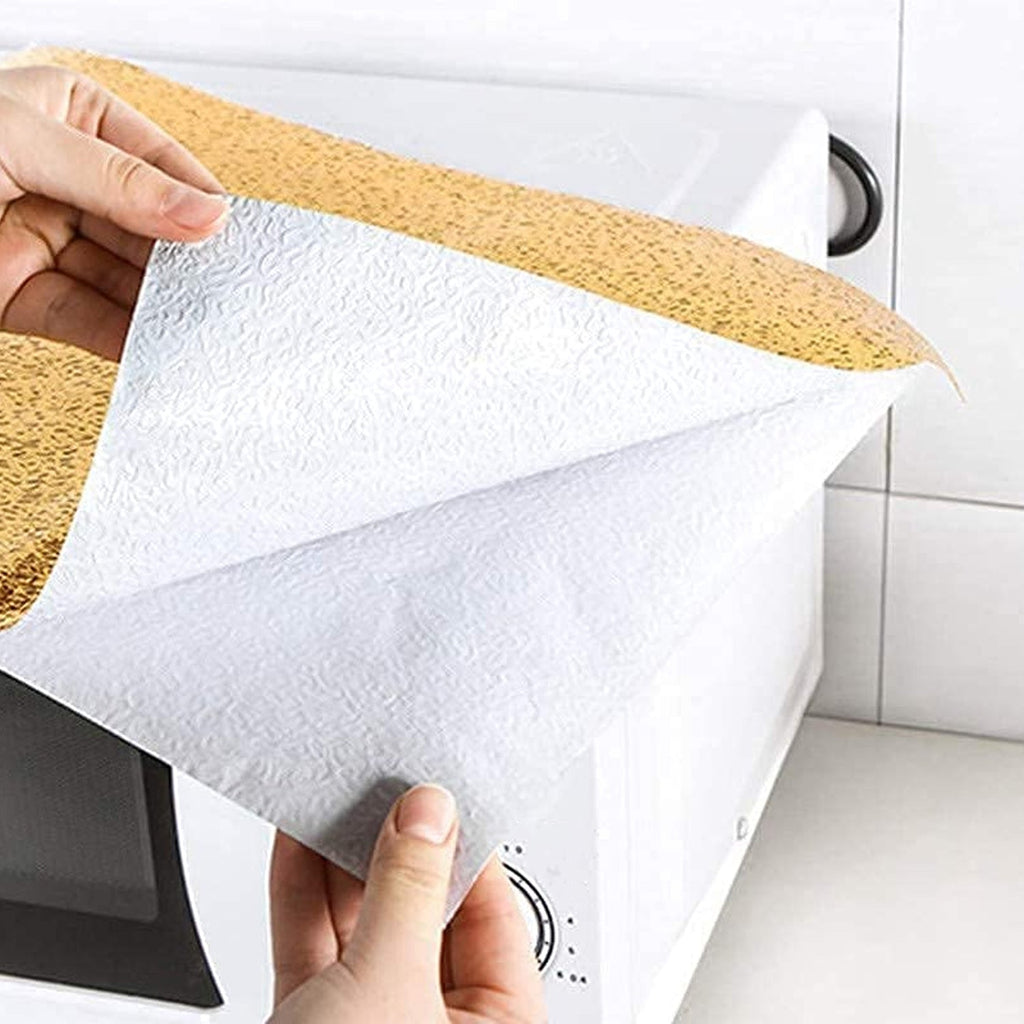 Oil-proof aluminum foil sticker protecting a kitchen countertop.