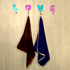 White heart-shaped self adhesive hook, ideal for hanging small items.