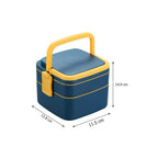 The blue double-layer bento lunch box with its lid off, showing the spoon inside.