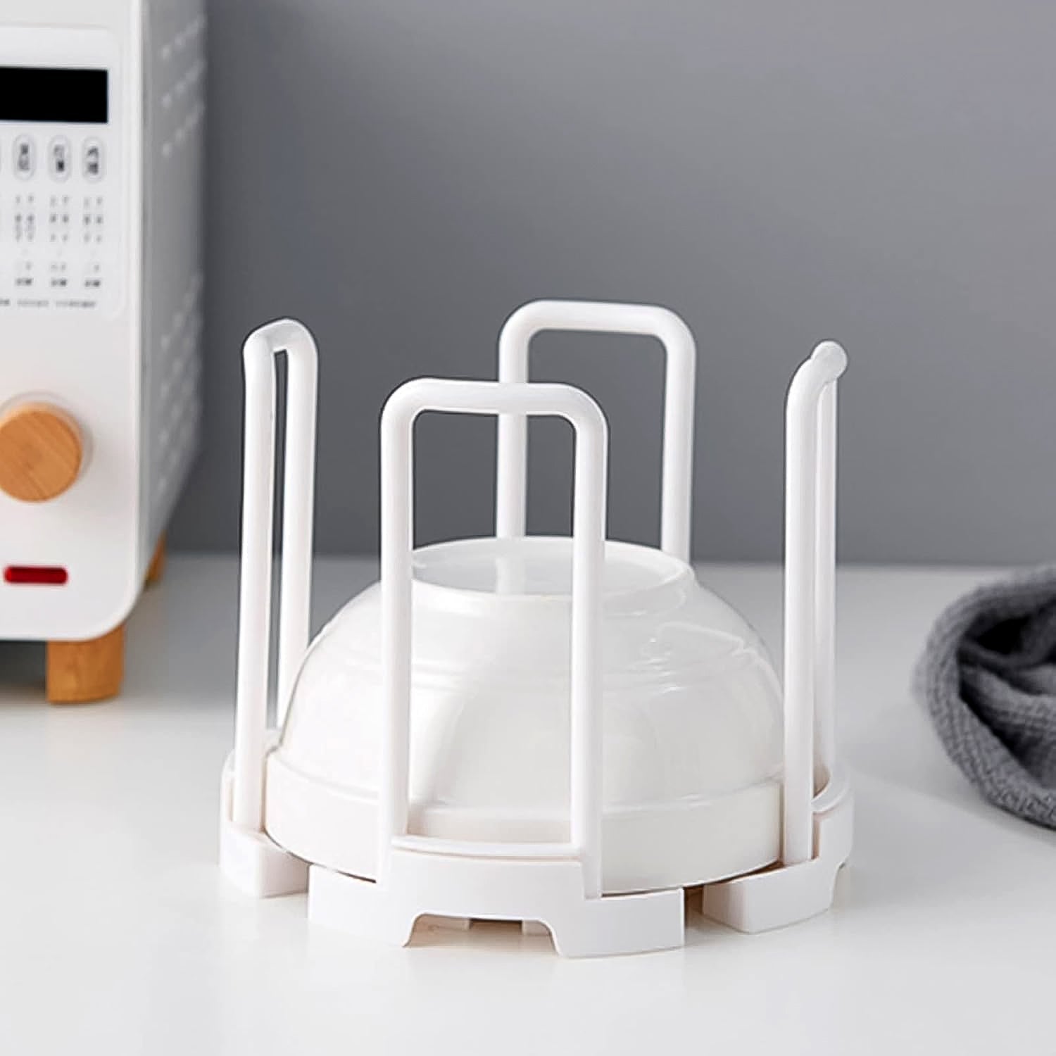 Stylish plastic kitchen organizer rack on a countertop next to a sink, ready for use.