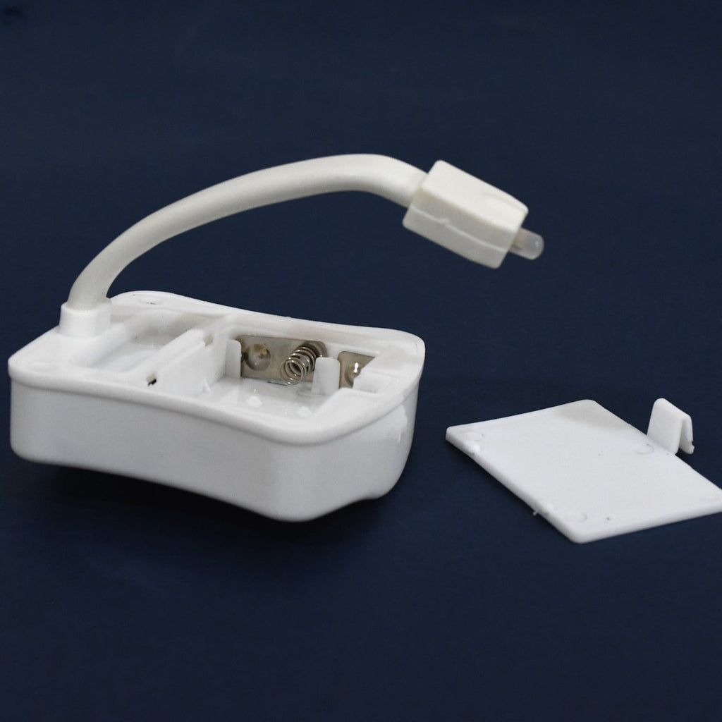 Underside of the LED toilet light showing the battery compartment for 3x AAA cells.