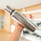 Close-up top view of stainless steel oil pourer showing wide mouth opening