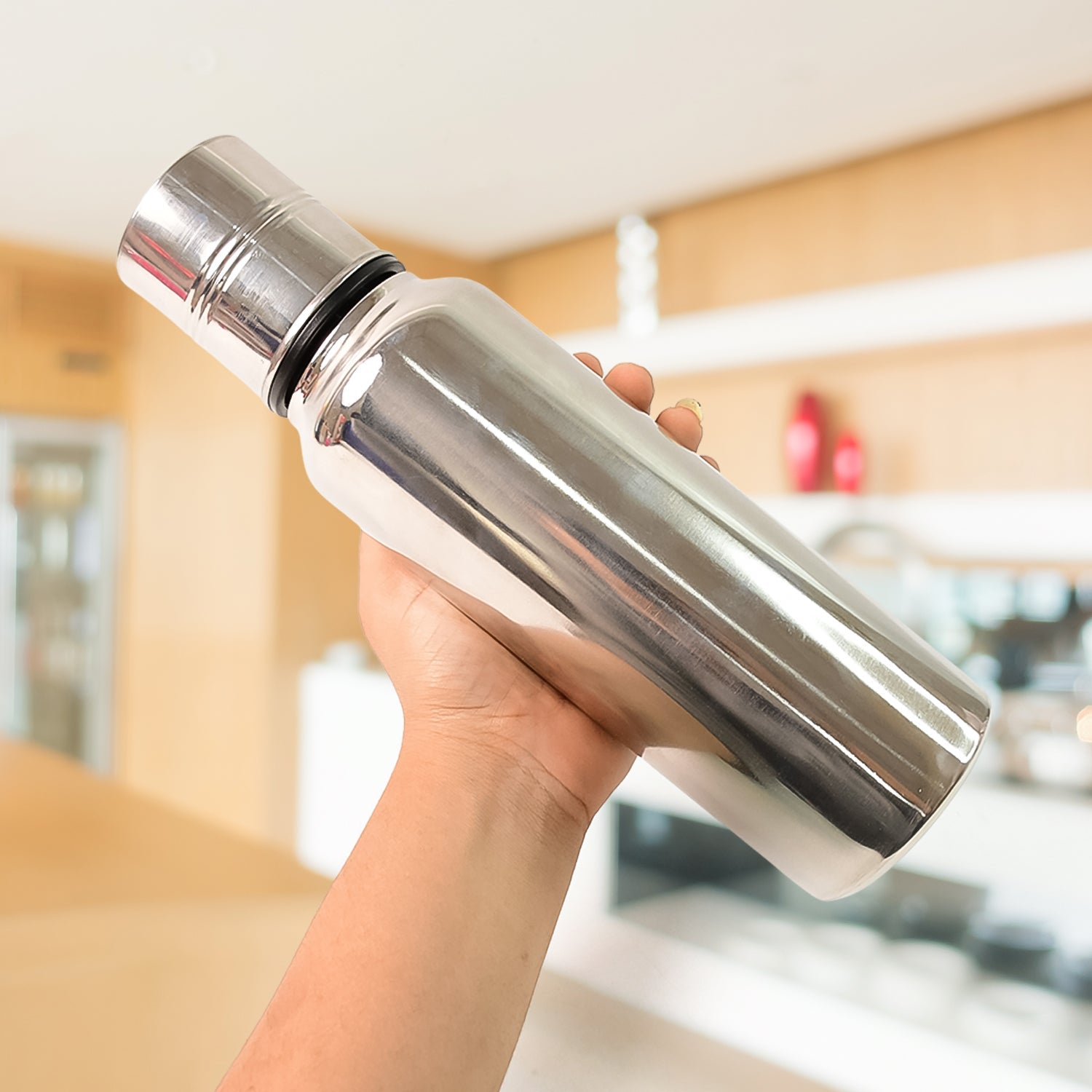 Close-up top view of stainless steel oil pourer showing wide mouth opening