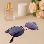 Foldable sunglasses holder mounted on wall with stylish sunglasses