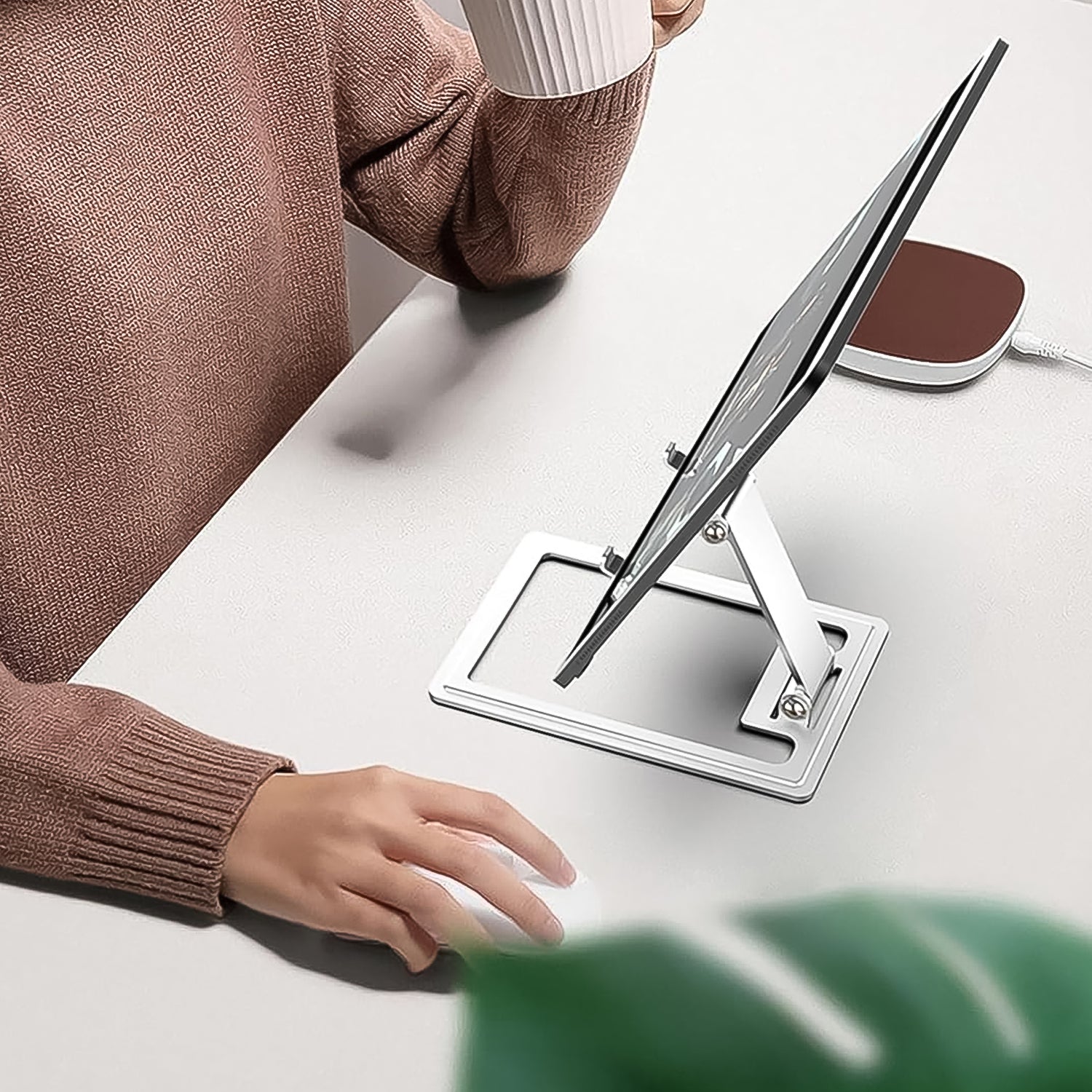 Ergonomic adjustable phone stand on a modern desk setup, enhancing productivity.