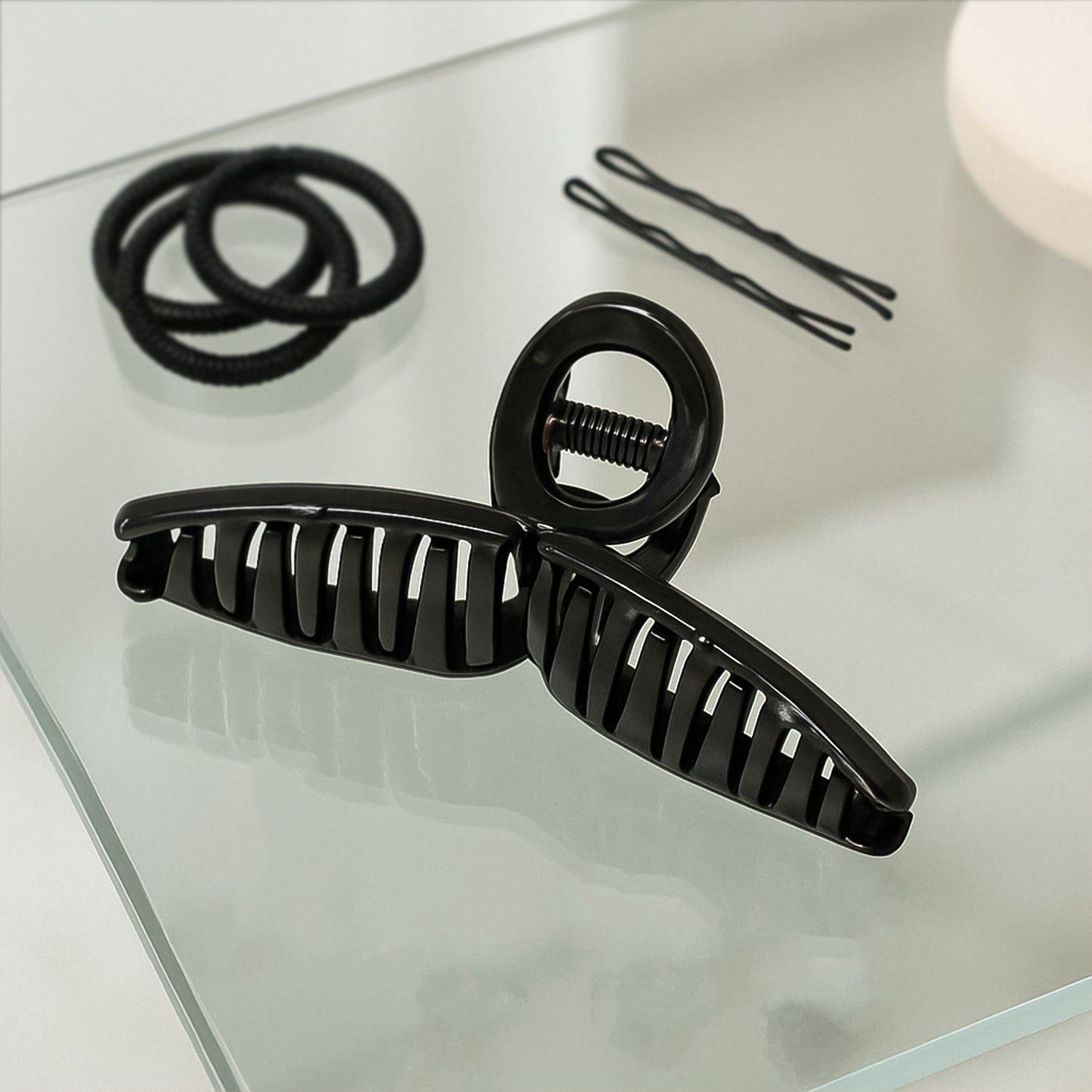 Back view of woman wearing hair claw clip holding elegant updo securely