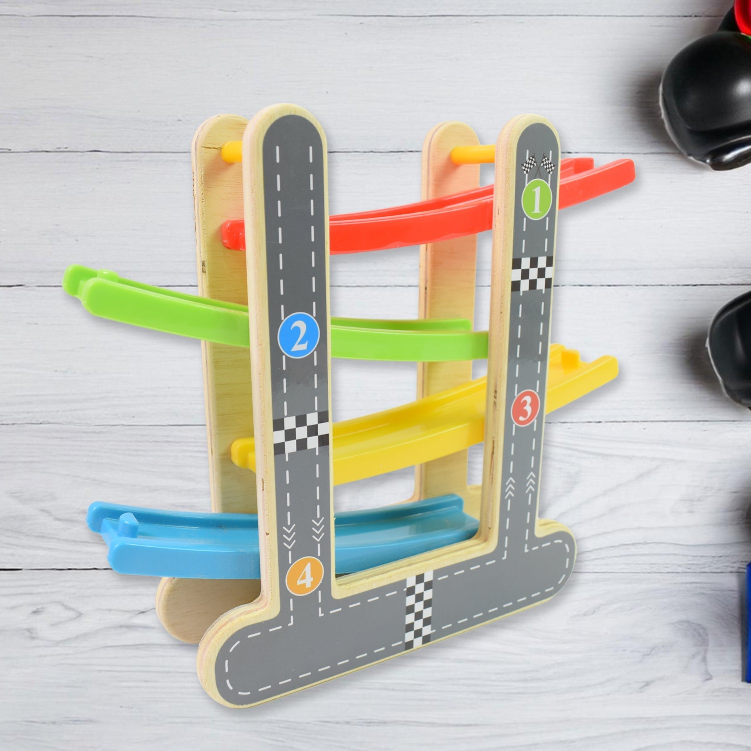 Close-up of the smooth wooden ramps and vibrant mini cars of the play set.