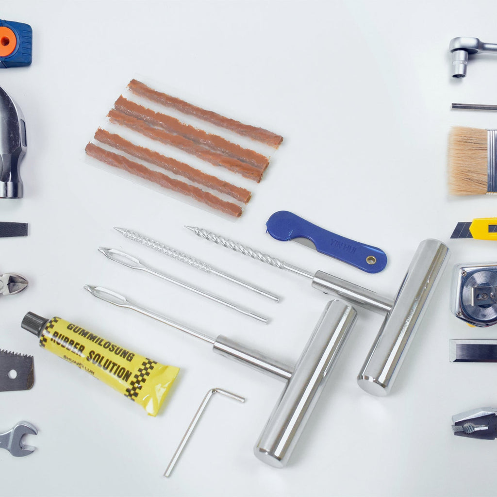 All 13 pieces of the emergency tire repair kit neatly arranged inside its durable storage box.