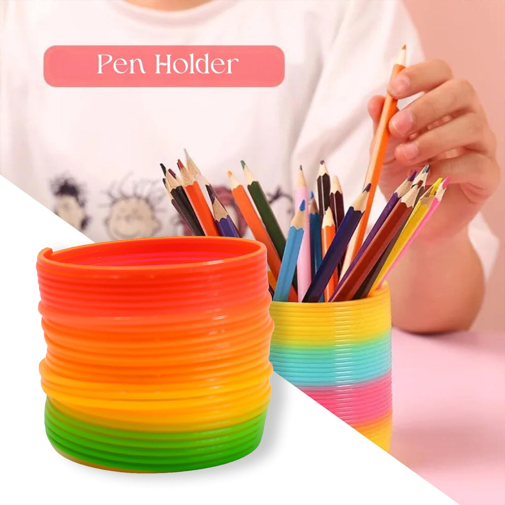A hand holding the Rainbow Slinky Toy, providing a clear reference for its portable size.