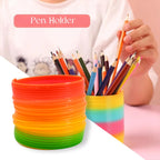 A hand holding the Rainbow Slinky Toy, providing a clear reference for its portable size.