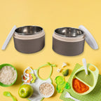 A collection of Ganesh stainless steel lunch boxes in various vibrant colors.
