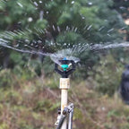 Detailed view of the rotating sprinkler nozzle's adjustable spray pattern.