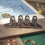 Metal paper clamp clips in use for office and home organization