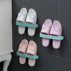 The self-adhesive towel rack effectively holding two bath towels and a pair of slippers.