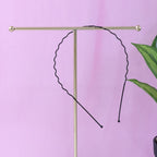 Individual metal wave hair band showing rounded protective tips