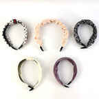 Flexible plastic base supports ribbed knot hairband’s durable design