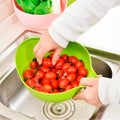 A Quickslice rice washing bowl with a thick drain basket and handle, perfect for kitchen use.