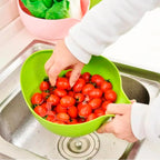 A Quickslice rice washing bowl with a thick drain basket and handle, perfect for kitchen use.
