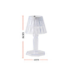 A modern mini crystal table lamp glowing softly in a contemporary interior.