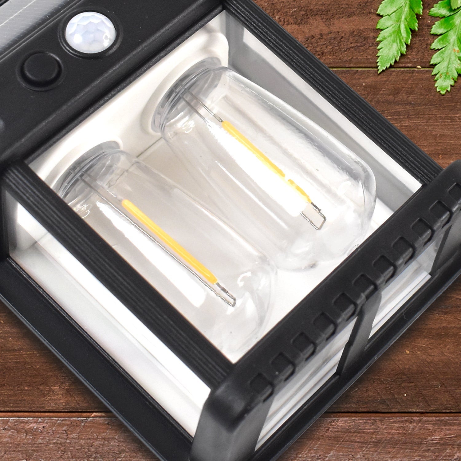 Solar-powered outdoor wall lamp with dual lighting and motion sensor