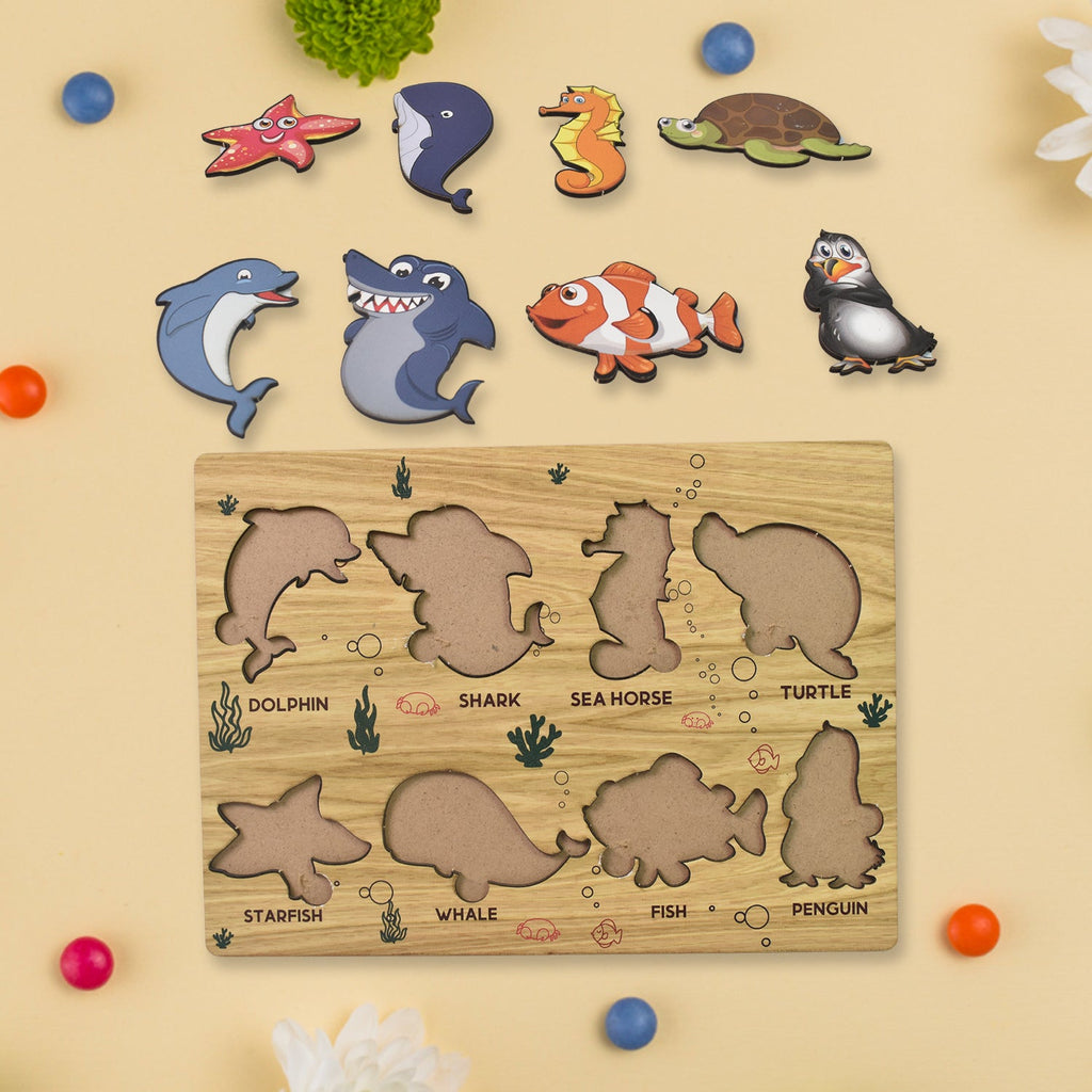 Close-up of individual wooden sea animal puzzle pieces, promoting fine motor skills.