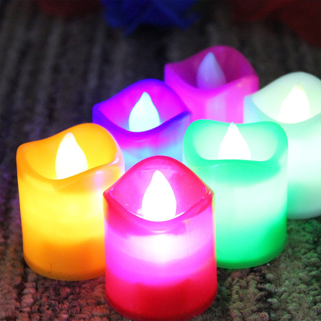 Hand holding a glowing LED tealight candle, showcasing its portability.